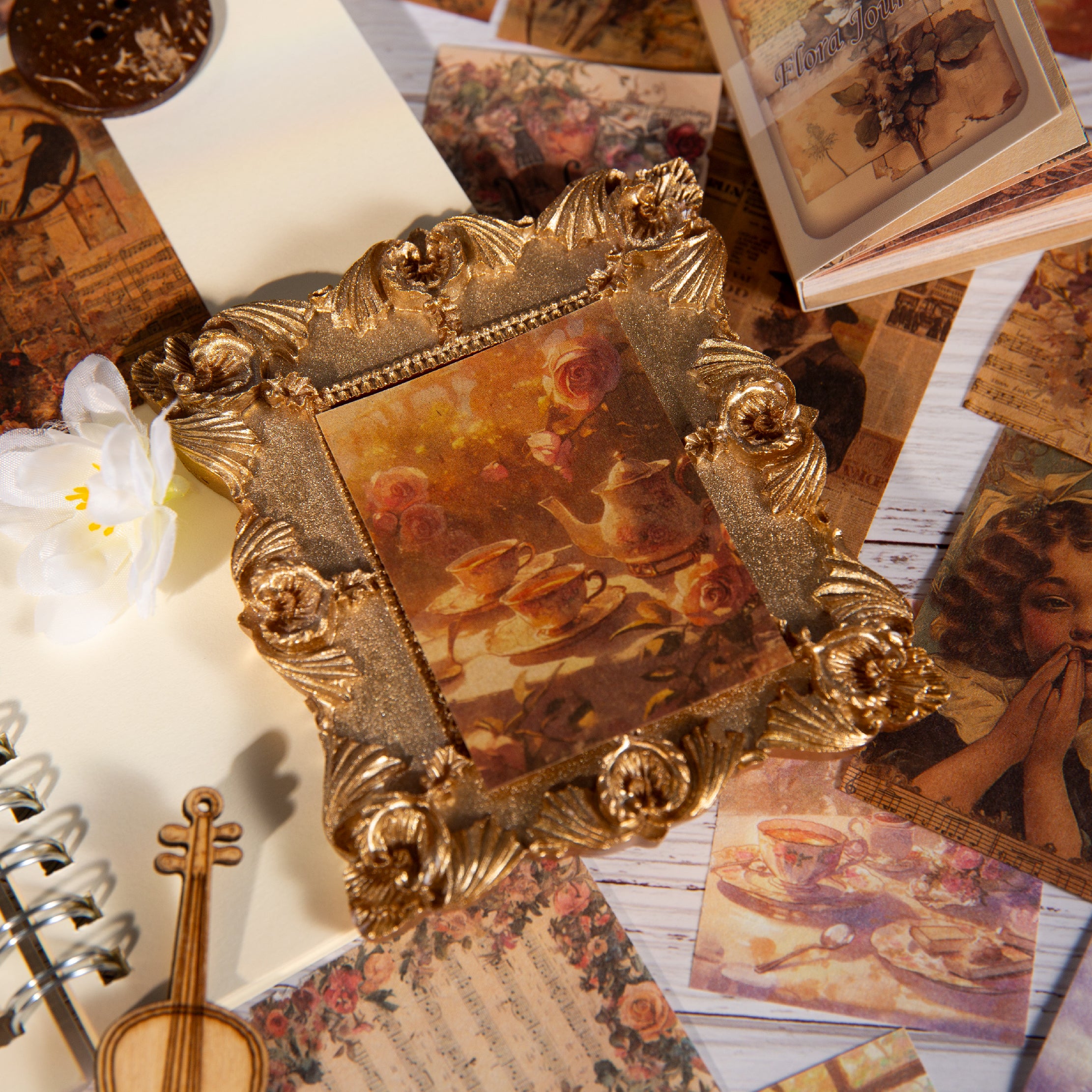 Close-up of vintage ephemera cards showing floral illustrations and Blossom Sonata text with soft warm light.