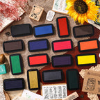 All 16 Star Printing ink pad colors arranged on kraft paper with sunflower