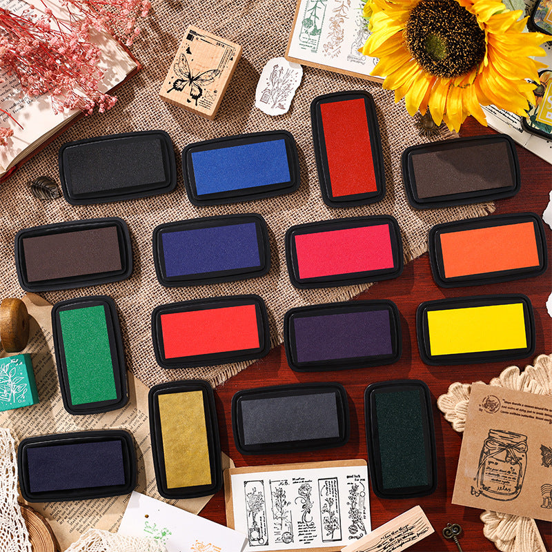 All 16 Star Printing ink pad colors arranged on kraft paper with sunflower