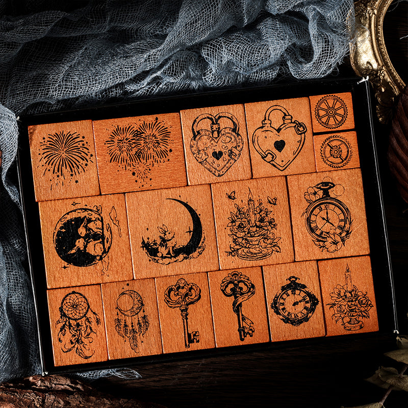 Top-down view of the 16 piece vintage fairy tale stamp collection neatly organized in its display box. Perfect for dark academia scrapbooking and bullet journal layering.