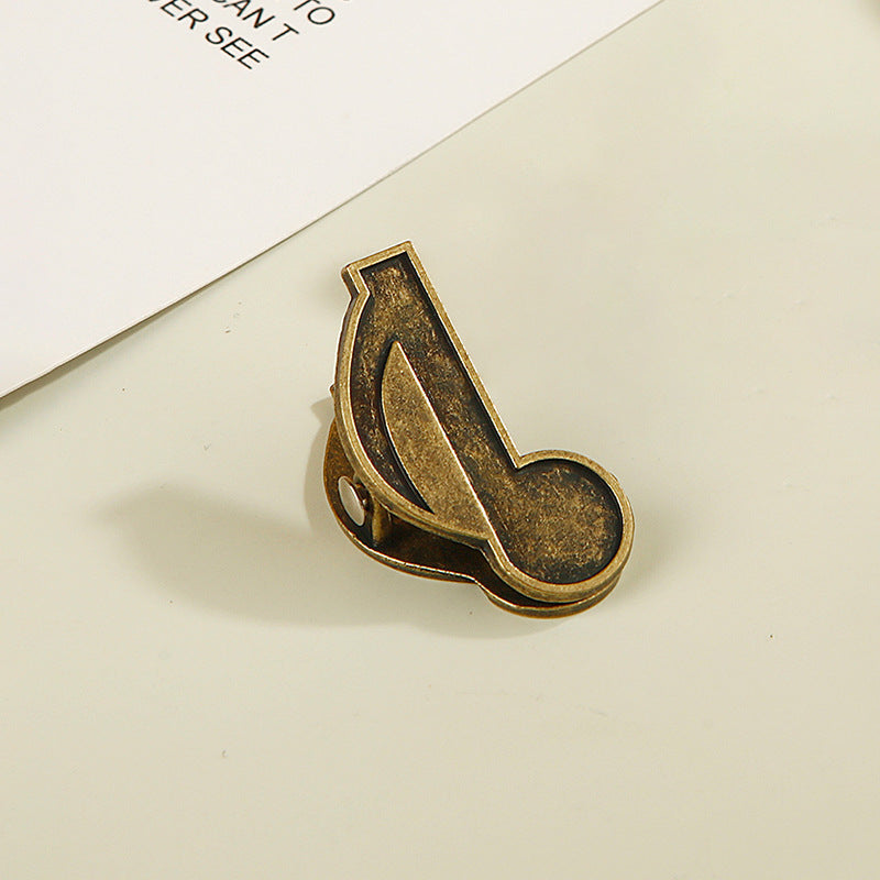 Single antique bronze eighth note heavy-duty clip for retro scrapbooking.
