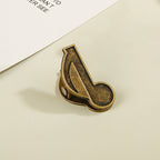 Single antique bronze eighth note heavy-duty clip for retro scrapbooking.