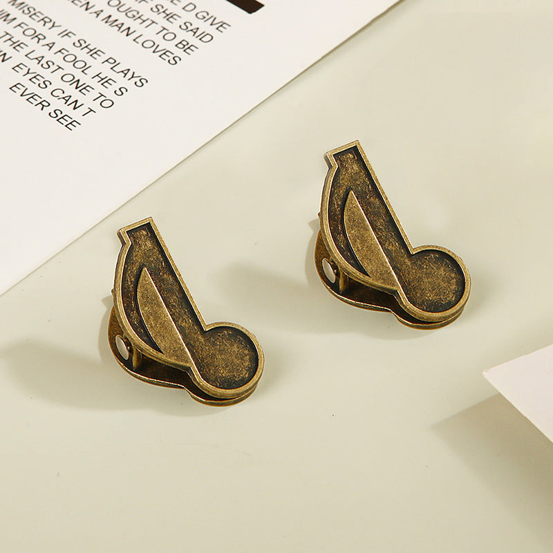 Set of two antique bronze eighth note musical clips for vintage stationery lovers.