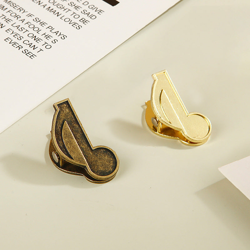 Mixed bundle of bronze and gold eighth note metal paper clips for junk journal supplies.