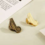 Mixed bundle of bronze and gold eighth note metal paper clips for junk journal supplies.