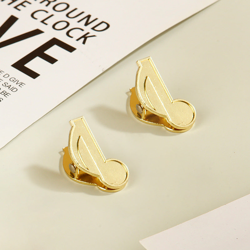 Two vintage gold eighth note metal clips designed for aesthetic planner organization.