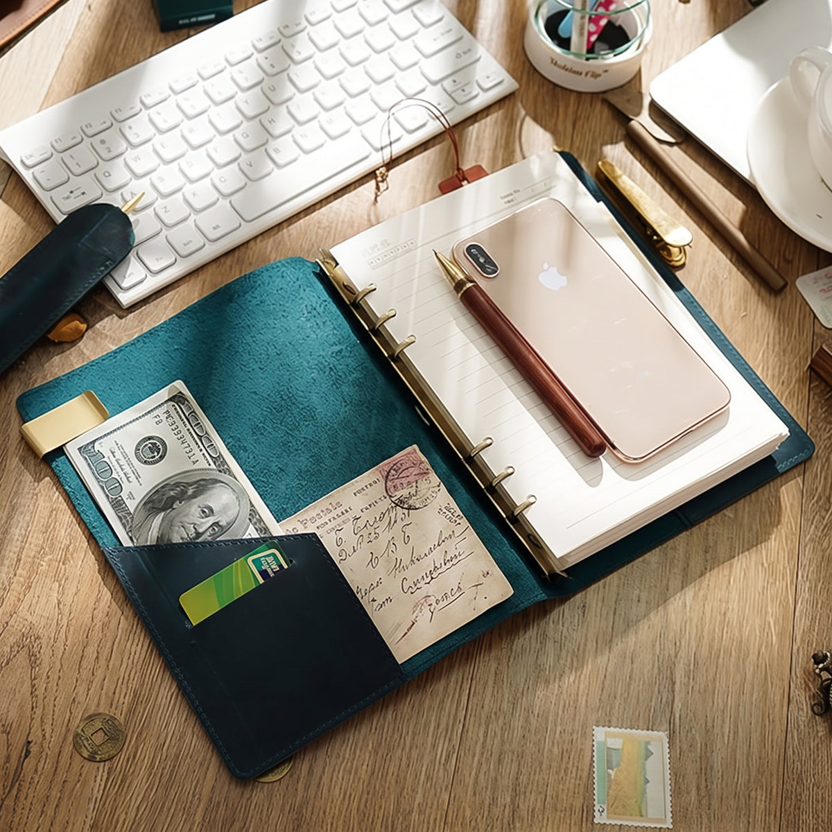Blue leather ring binder journal with card pockets and pen on desk