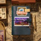 Dark green leather journal cover decorated with vintage stickers and travel ephemera