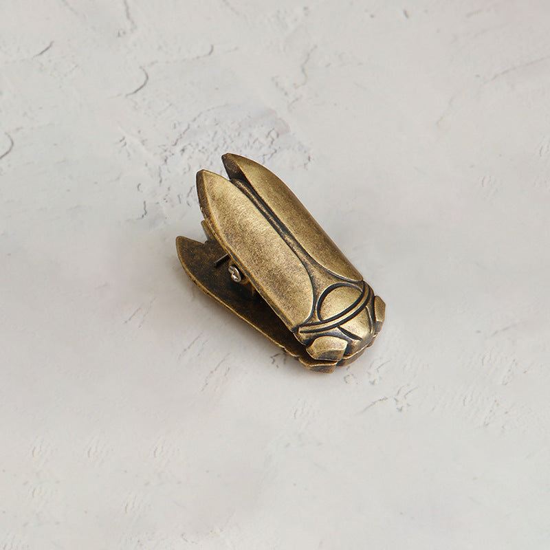 Single Aged Antique Bronze vintage cicada metal paper clamp. A heavy-duty antique style book holder clip for Dark Academia desk setups.