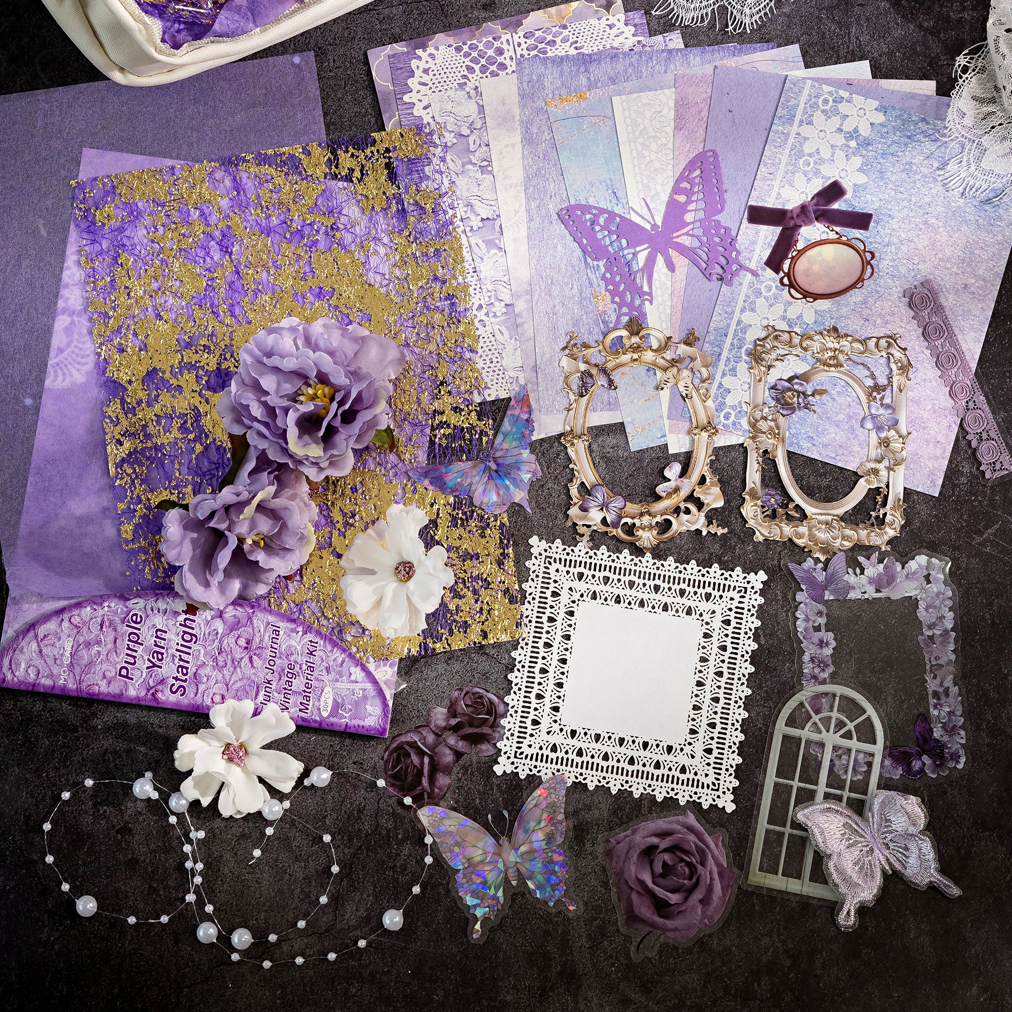 Variant image of the Amethyst Twilight style Premium Mixed Media Junk Journal Kit in its purple and violet packaging. Shows the 30 mythical pieces including elaborate laser-cut butterfly frames, holographic PET stars and gauze elements, and mystic textured background papers.