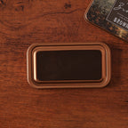 Vintage iron box ink pad in Antique Bronze open on wood, bronze botanical lid beside