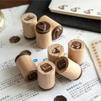 Beech wood dessert stamps scattered on paper with coffee beans and journal pages