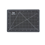 Black A5 self-healing cutting mat with white grid lines and inch rulers
