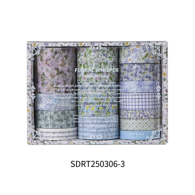 Close-up of Blue Haze misty blue washi tape rolls, showing soft watercolor floral patterns and sky-toned botanical designs