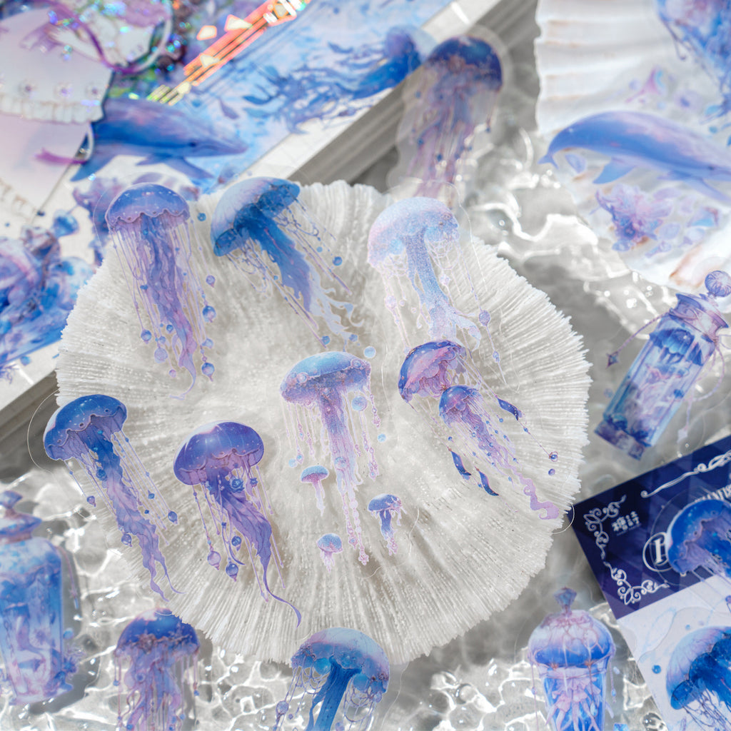 Blue translucent jellyfish stickers drifting over white fabric