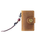 Brown mini leather notebook charm with snap closure on white