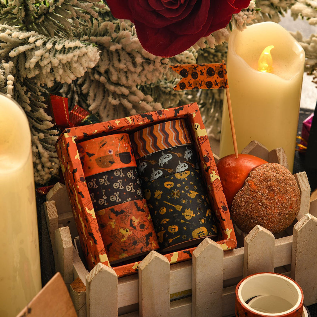 Halloween washi tape boxes styled with lit candles and dried flowers