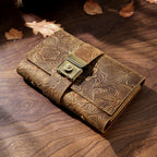 Carved brown leather lock journal A6 closed on wooden desk with autumn leaves