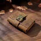 Carved brown leather lock journal A7 closed on wooden desk with leaves