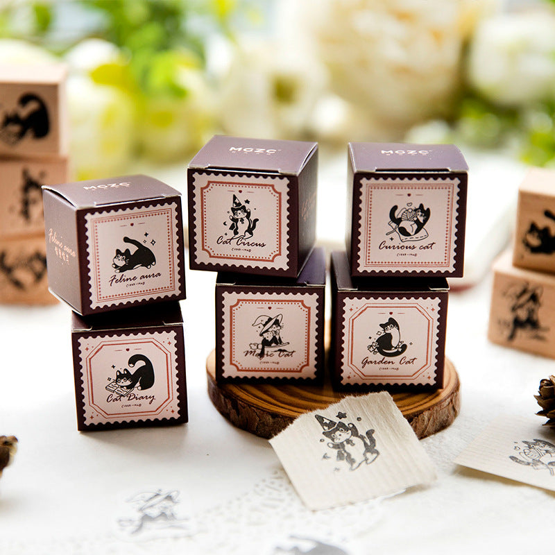Complete collection of six vintage cat rubber stamps arranged on a green botanical background, featuring beech wood handles and whimsical black cat illustrations