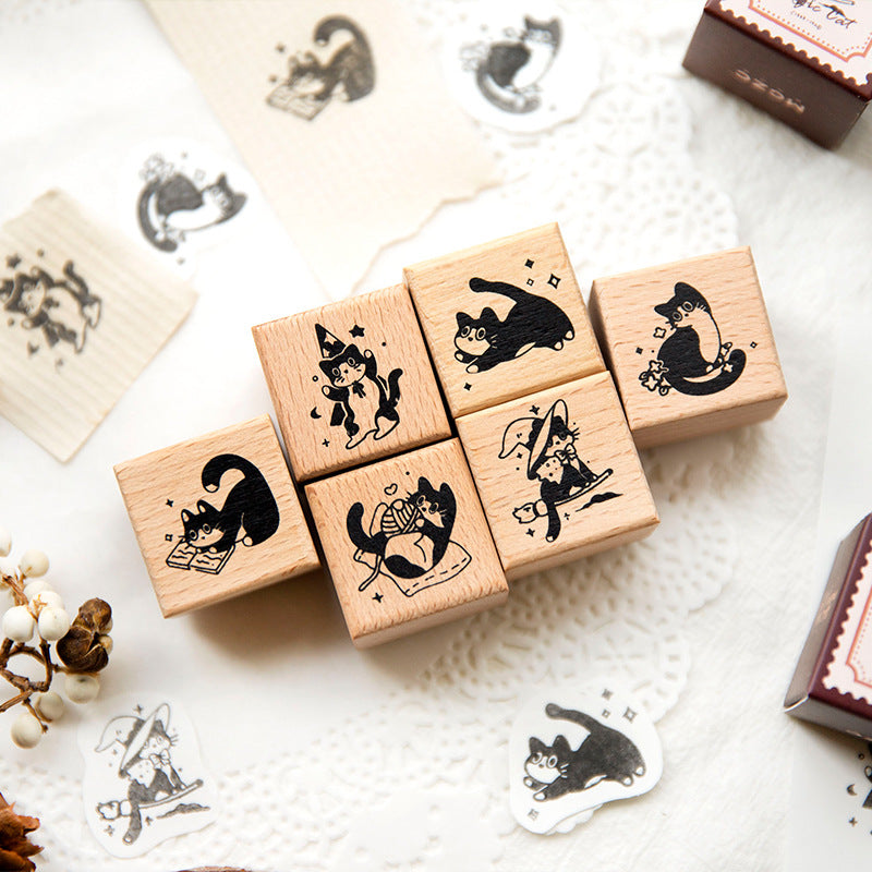 Six vintage cat stamp designs laid flat showing whimsical kitten illustrations including circus cat, garden cat, and magic cat for planner decoration