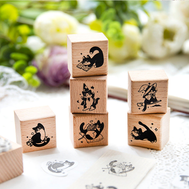Vintage wooden cat rubber stamps stacked with floral decor, showcasing beech wood construction and detailed silicone stamp faces