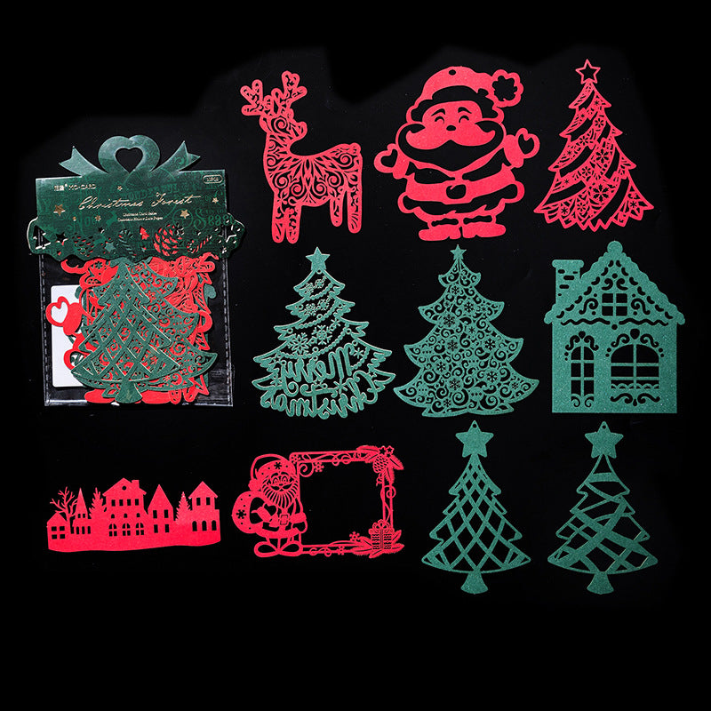 Red and green laser cut Christmas trees reindeer and houses on black