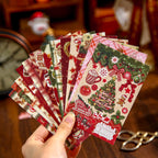 Hand fanning glitter Christmas sticker sheets - red and green holiday designs with trees, gifts and snowmen