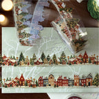 	Christmas PET washi tape strips laid across festive paper with fairy lights and ornaments