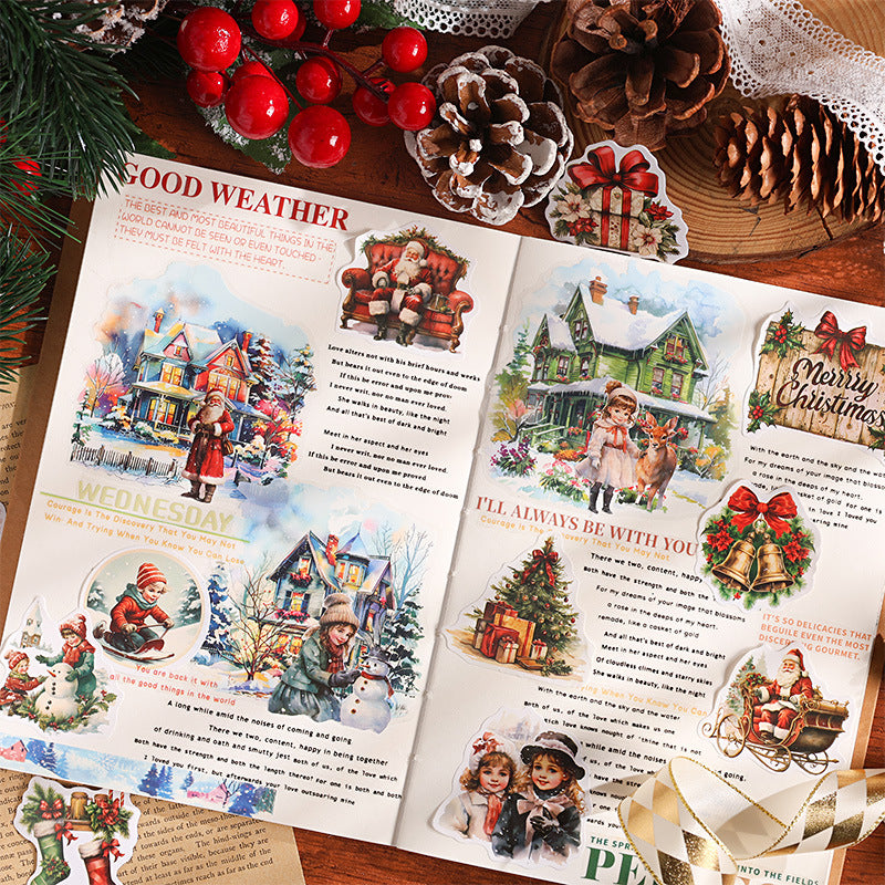 Open journal spread decorated with vintage Christmas sticker flakes showing Santa wreaths and holiday scenes on aged pages