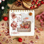 Christmas sticker sheet displayed on a clipboard journal with red berries and twine