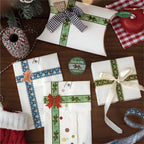 Christmas PET tapes beside gift-wrapped packages with plaid ribbon and wax seals