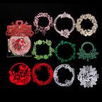 Red green and white laser cut Christmas wreath paper pieces on black