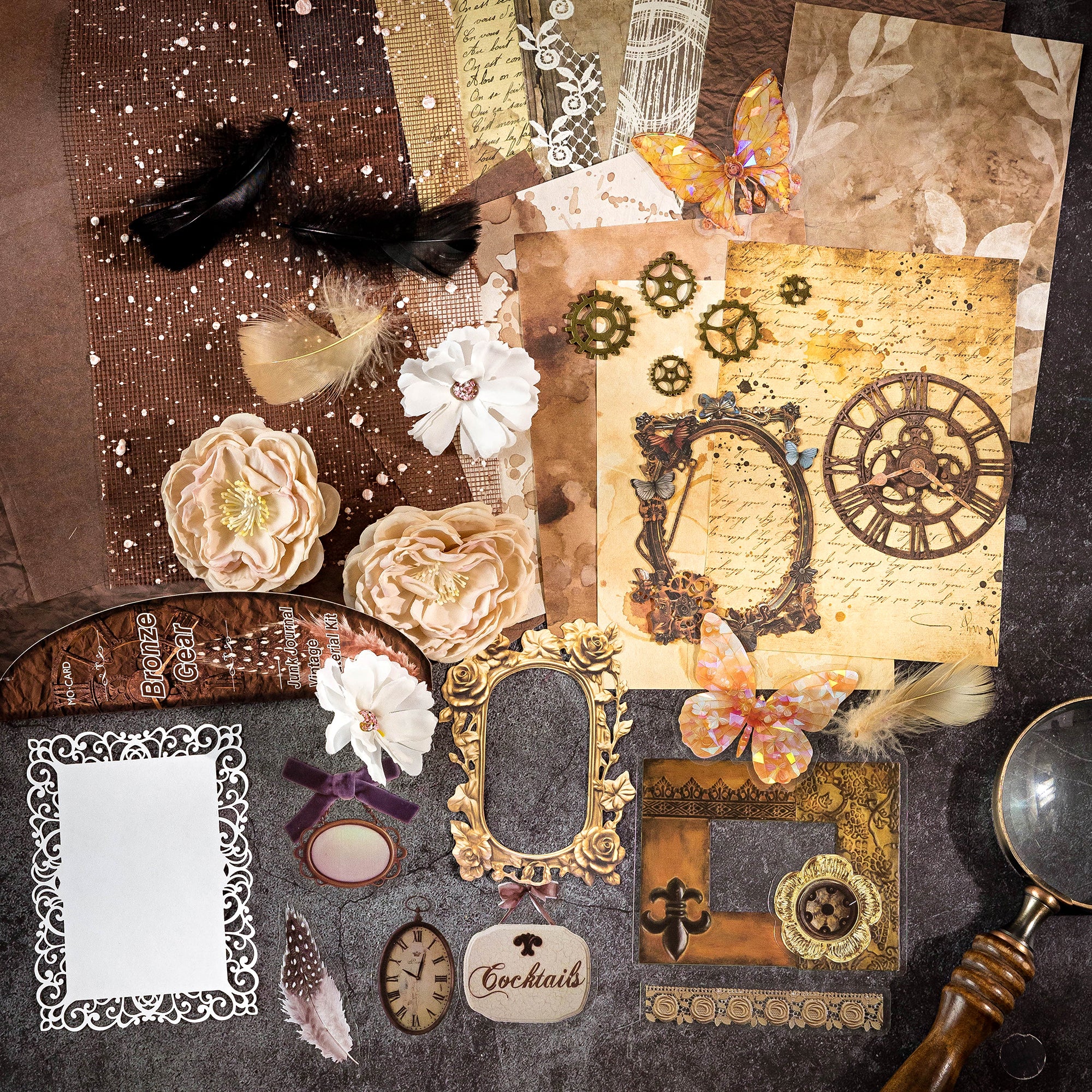Variant image of the Clockwork Bronze style Premium Mixed Media Junk Journal Kit in its antique brown and copper packaging. Shows the 30 steampunk-themed pieces including intricate laser-cut gear frames, holographic PET cogs, rustic kraft paper, and textured background papers.