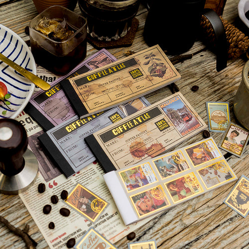 Close-up of gold foil coffee themed decorative paper showing vintage illustrations and washi paper texture
