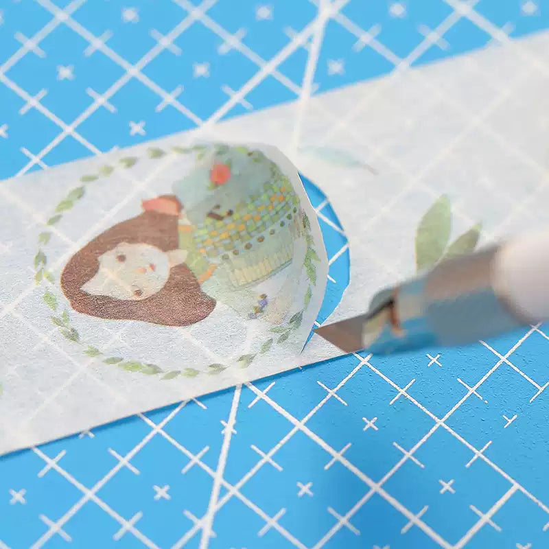 Hand cutting paper tape with a precision craft knife on cutting mat