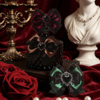 Dark gothic bow stickers styled with black roses and antique bust on red velvet