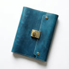 Deep Sapphire authentic leather notebook with a heavy-duty metal combination lock and retro compass cover for secure creative writing.