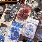 Delusional Rose PET sticker packs in four styles — black, red, white and blue rose designs on vintage paper