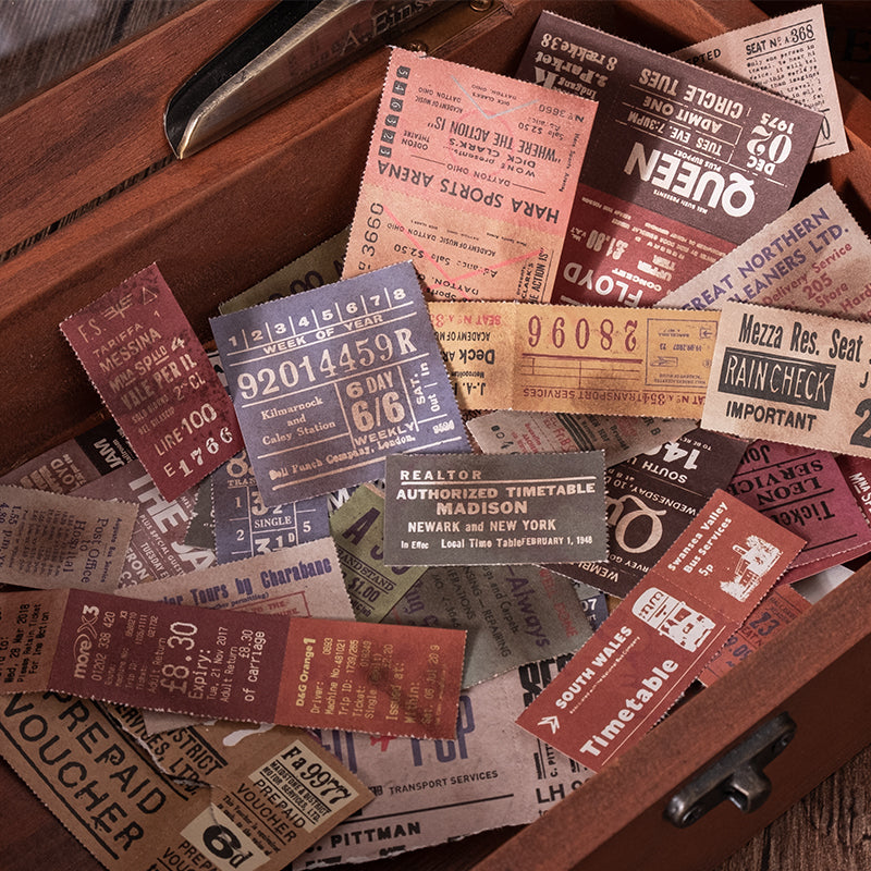 Close-up detail of vintage train ticket stickers showing authentic retro typography