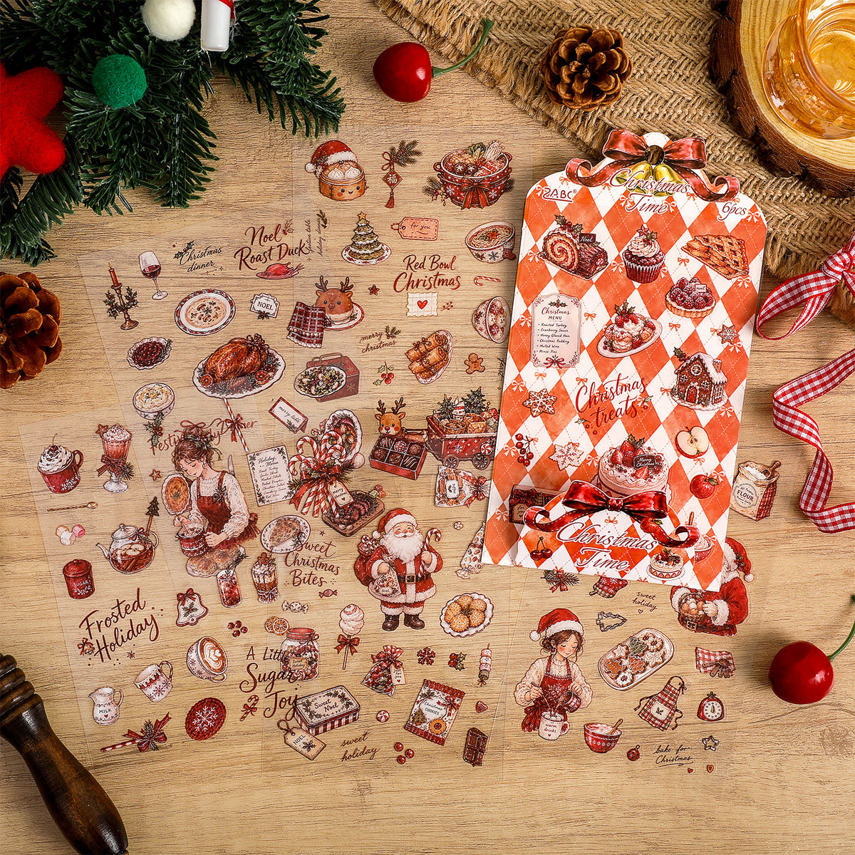 Close-up of die-cut Christmas sticker sheet on kraft paper beside red baubles and dried orange slices