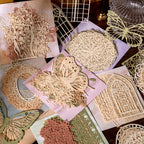 Close-up of die-cut lace stickers showing intricate hollow patterns for scrapbooking and wedding crafts
