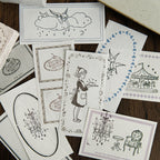 Stamped impression cards with baking girl and ballet motifs scattered on white paper