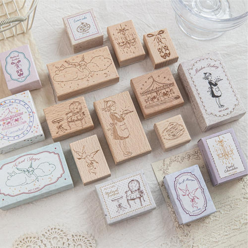 Dream Imprint beech wood stamp collection scattered on cream paper with fairy-tale stamped impressions