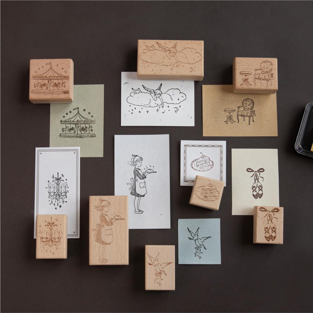 Beech wood fairy-tale stamps arranged on a dark background with stamped sample cards