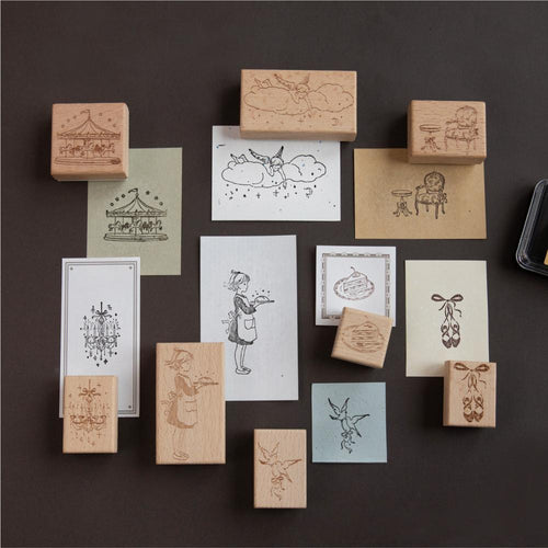 Beech wood fairy-tale stamps arranged on a dark background with stamped sample cards