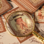 Closeup of victorian girl portrait sticker under magnifying glass lace frame details