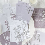 Close-up of silver foil stamping and raised relief embossing on premium paper