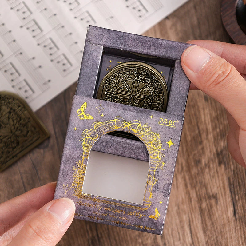 Hand pulling a zinc alloy clip from the gold-embossed purple gift box
