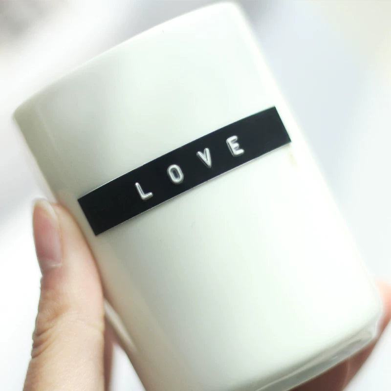 Black embossed LOVE label made with a manual label maker on a cup